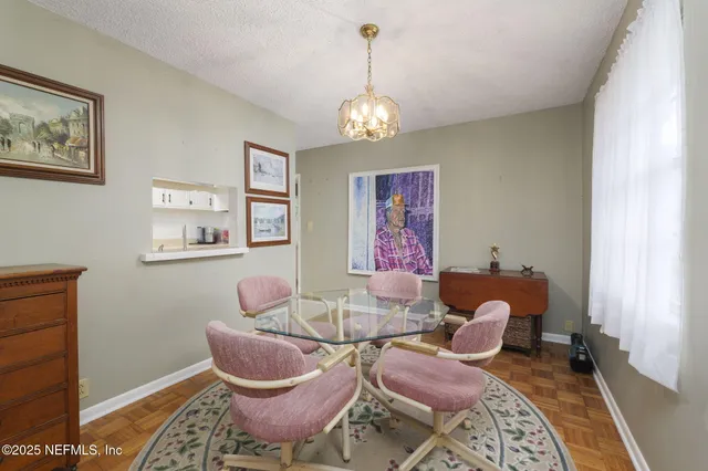 a dining room with furniture and window