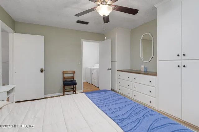 a bedroom with a bed and a dresser