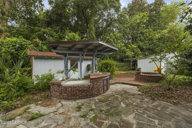 a view of a chair and table under an umbrella