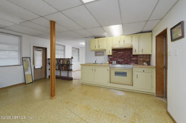 a kitchen with a stove a sink and a refrigerator