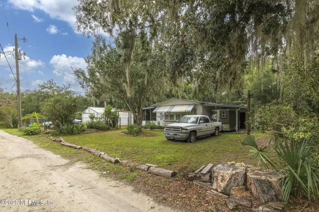 a view of a house with truck parked on the road