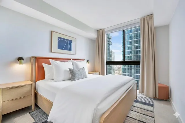 a bedroom with bed and window