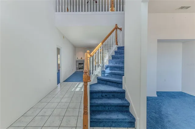 a living room with furniture a fireplace and a large window