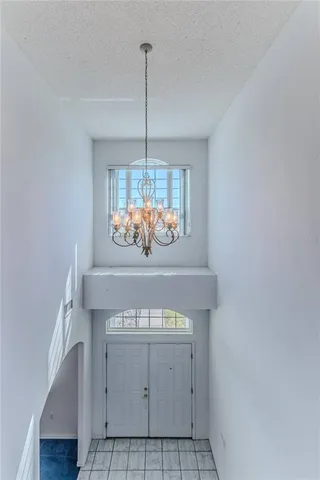 a view of an empty room with a fireplace and a window