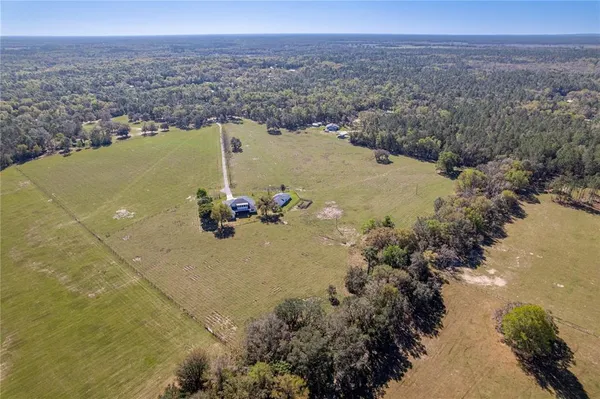 an aerial view of a houses with a lake view