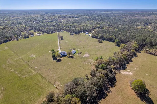 an aerial view of a houses with a lake view