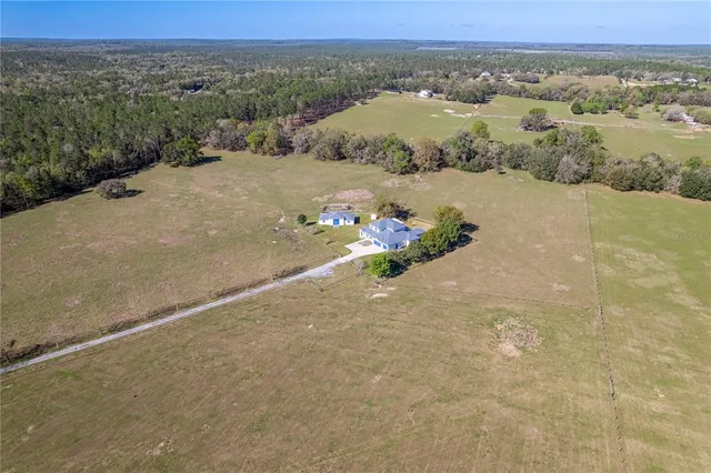 a bathroom with a granite countertop toilet a sink and a mirror