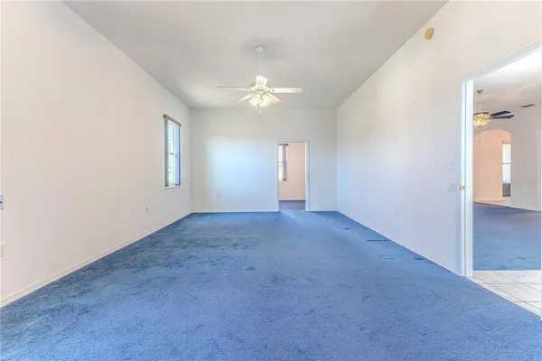 a front view of a house with swimming pool and large trees