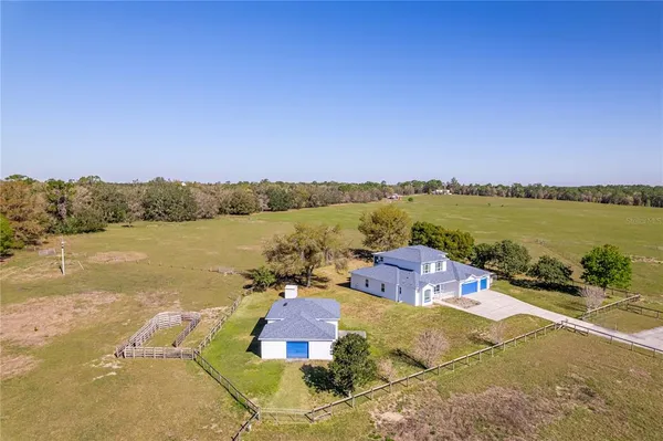 a view of a bedroom with wooden floor and windows