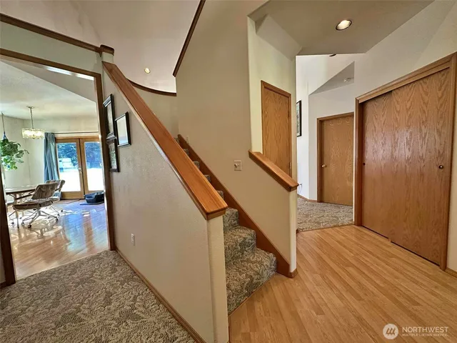 a view of entryway and hall with wooden floor