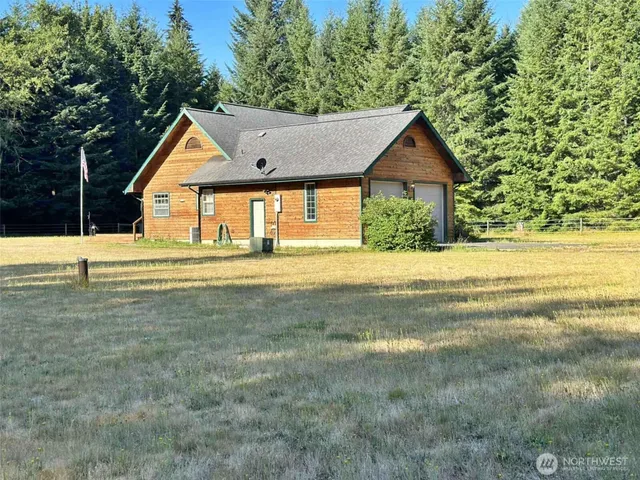 a front view of house with yard and green space