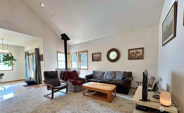 a living room with furniture a rug and a window