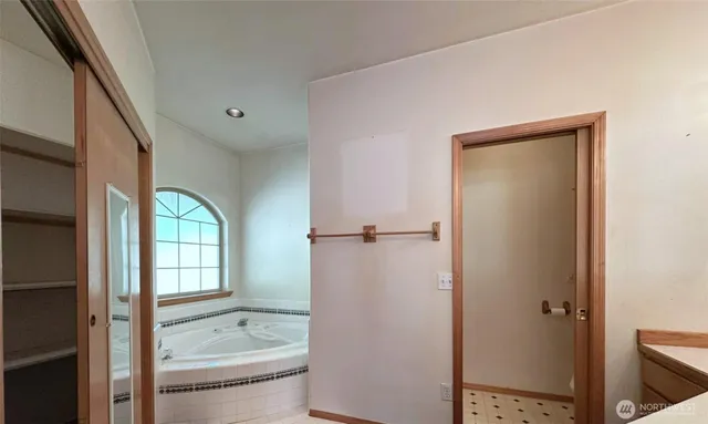 a bathroom with a granite countertop toilet a sink and shower