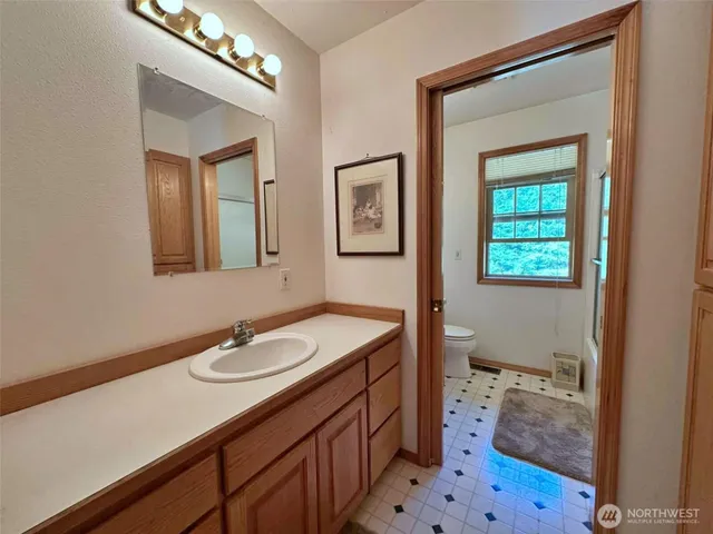 a bathroom with a sink a vanity and a mirror