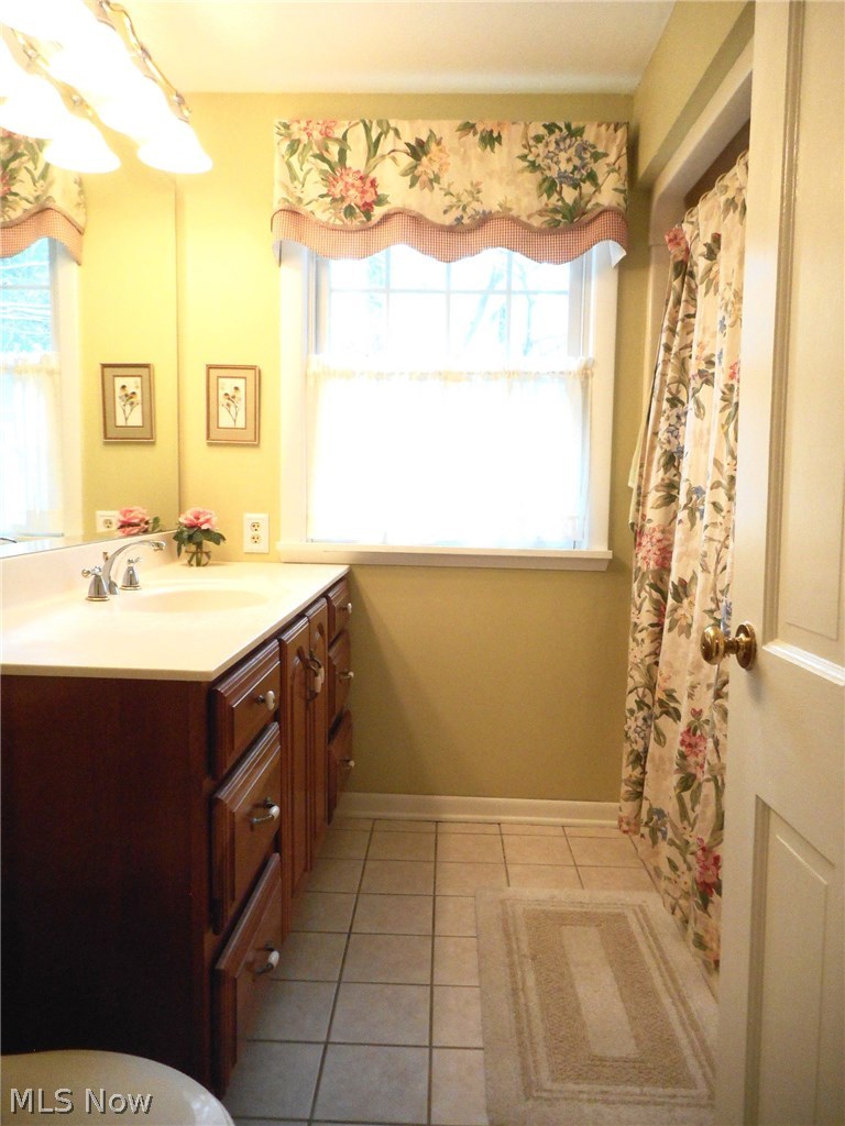 856 Old Spring Road Akron, OH 44321 - Photo 17 of 30 The bathroom also has cherry cabinet and tiled floor.