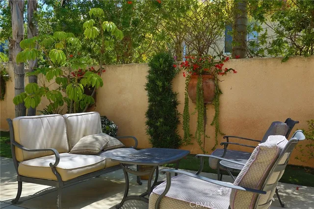 a balcony with table and chairs