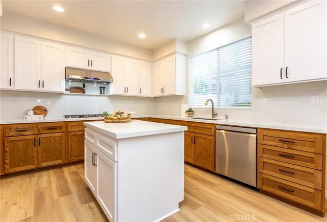 a kitchen with a sink window and cabinets