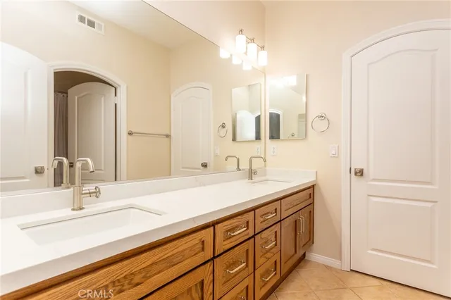 a bathroom with a double vanity sink and a mirror