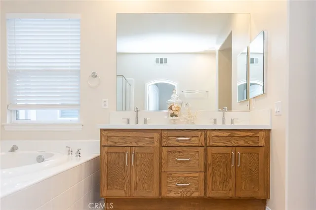 a spacious bathroom with a granite countertop sink and a mirror
