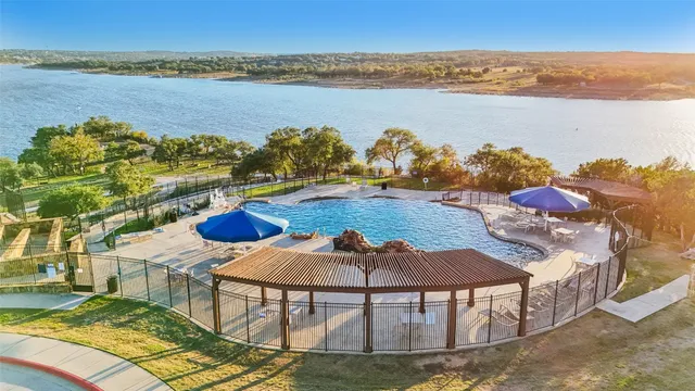 an aerial view of a house with yard swimming pool and outdoor seating