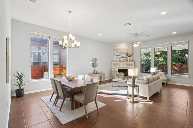 a view of a dining room with furniture wooden floor and a chandelier