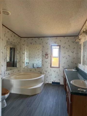 a view of a bathroom with a tub sink and mirror