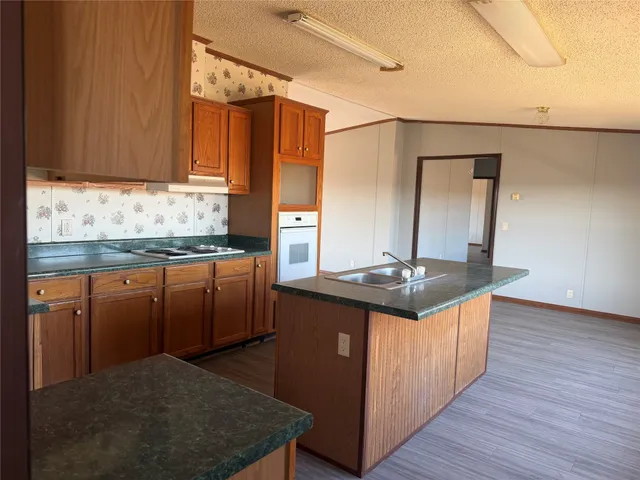 a kitchen with stainless steel appliances granite countertop a sink stove and cabinets