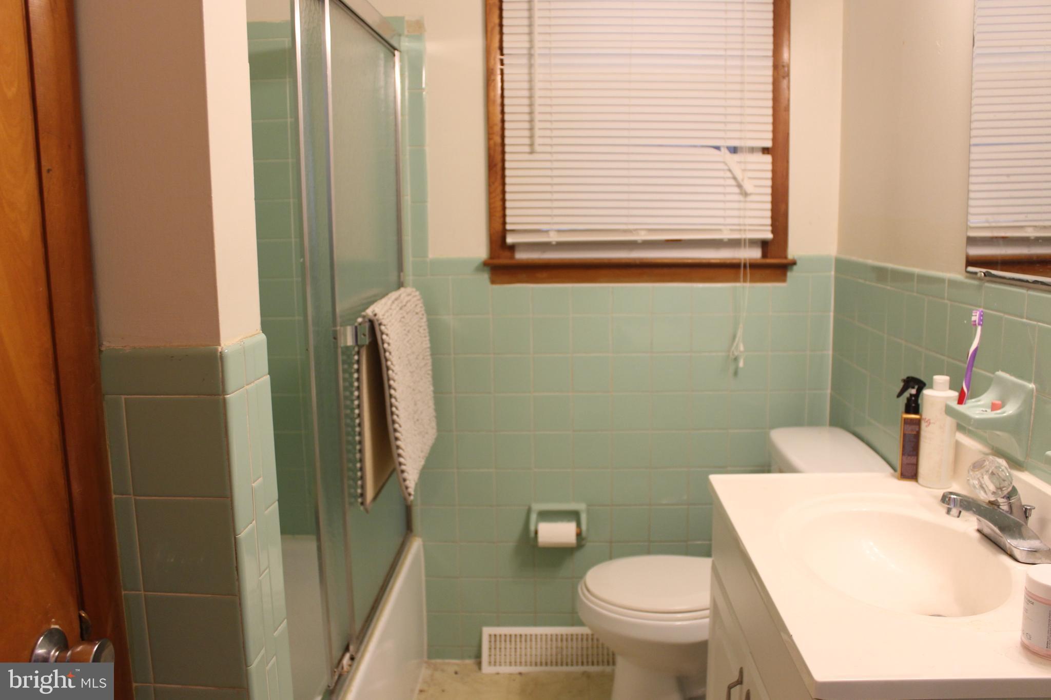 107 Laurel Avenue Glassboro, NJ 08028 - Photo 11 of 17 a white toilet sitting next to a bathroom sink and tub