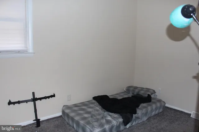 a bed sitting in a bedroom next to a window