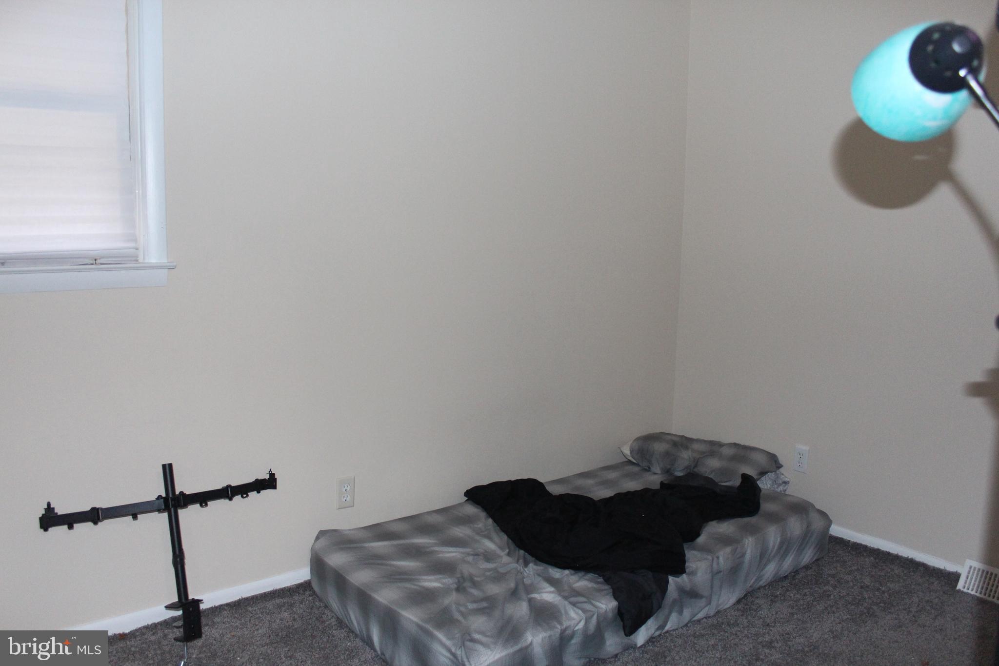 107 Laurel Avenue Glassboro, NJ 08028 - Photo 5 of 17 a bed sitting in a bedroom next to a window