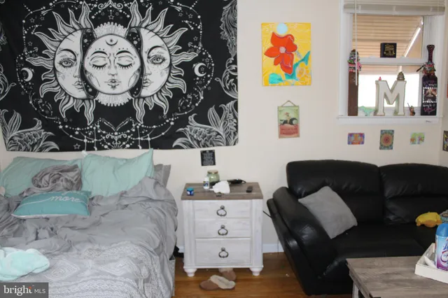 a living room with furniture and wall paintings