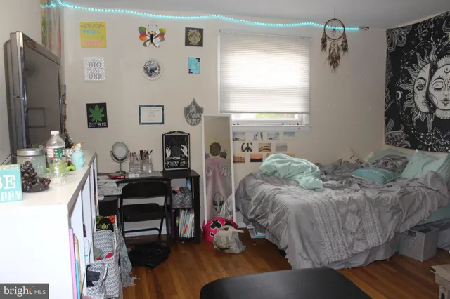 a bed room with a bed window and a chair