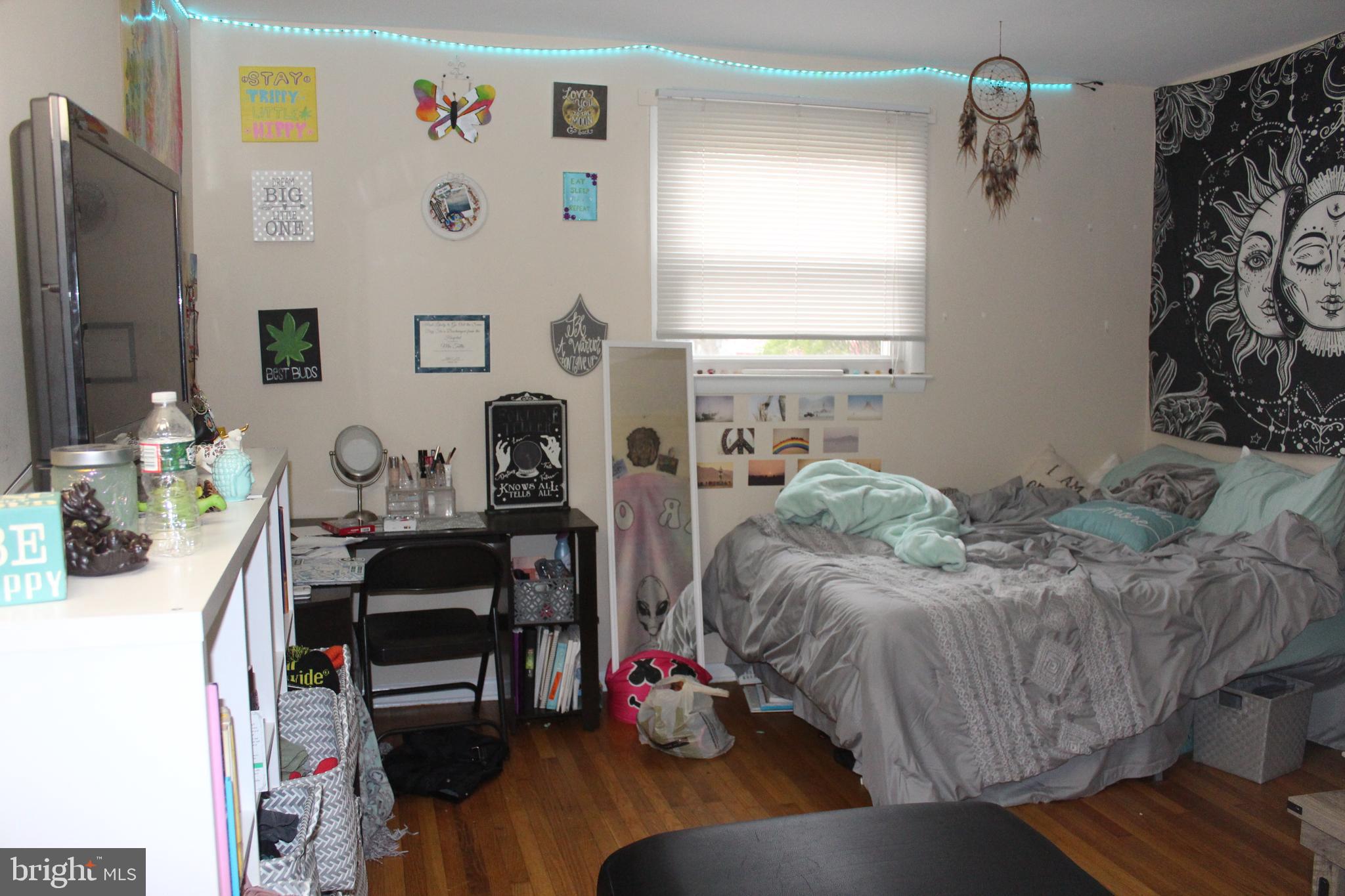 107 Laurel Avenue Glassboro, NJ 08028 - Photo 7 of 17 a bed room with a bed window and a chair