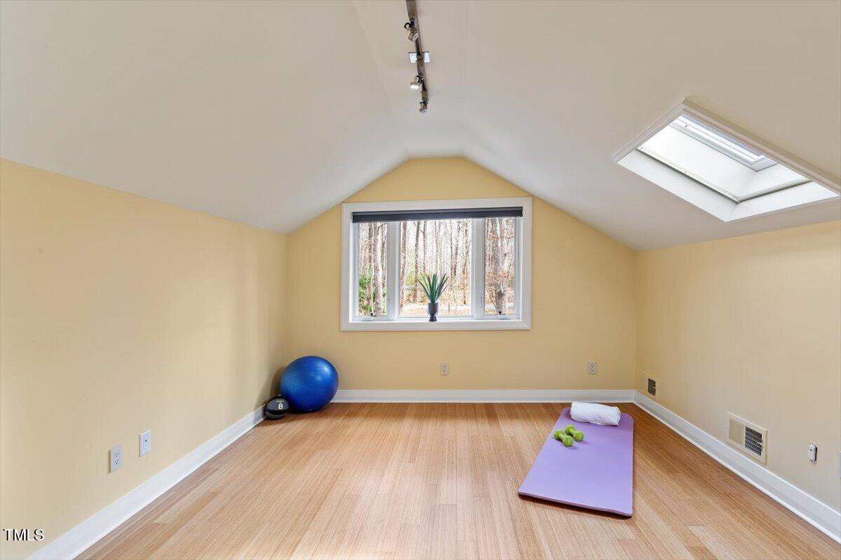 10729 Trego Trail Raleigh, NC 27614 - Photo 34 of 65 Bedroom Four with Hardwood Floors and Skylight.