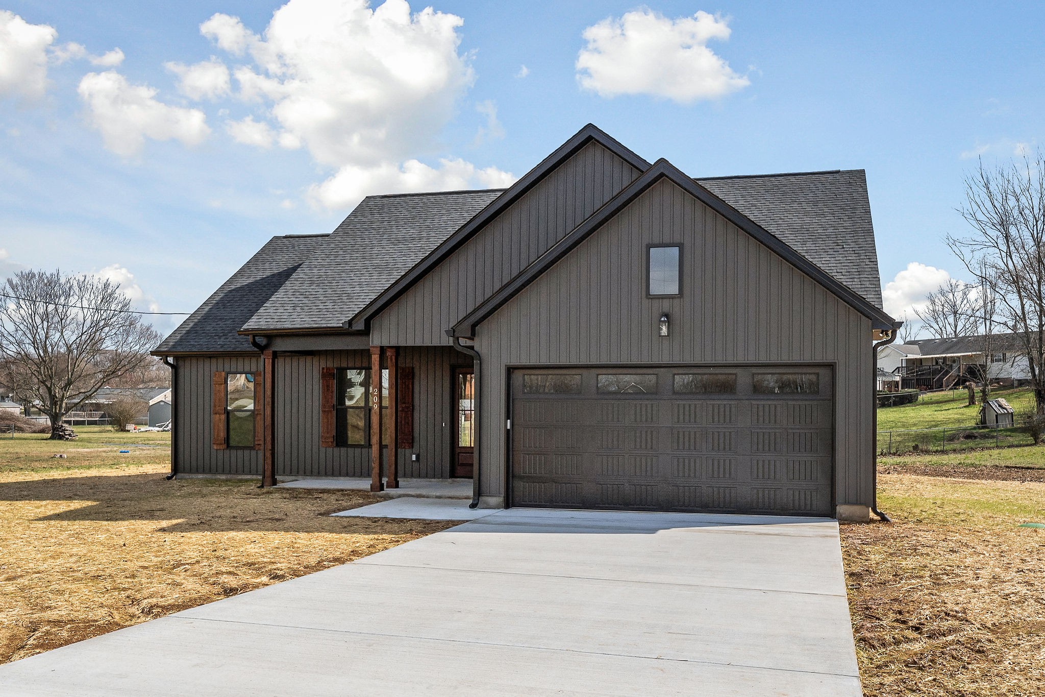 209 Brandon Drive McMinnville, TN 37110 - Photo 2 of 31 a front view of a house with a yard and garage
