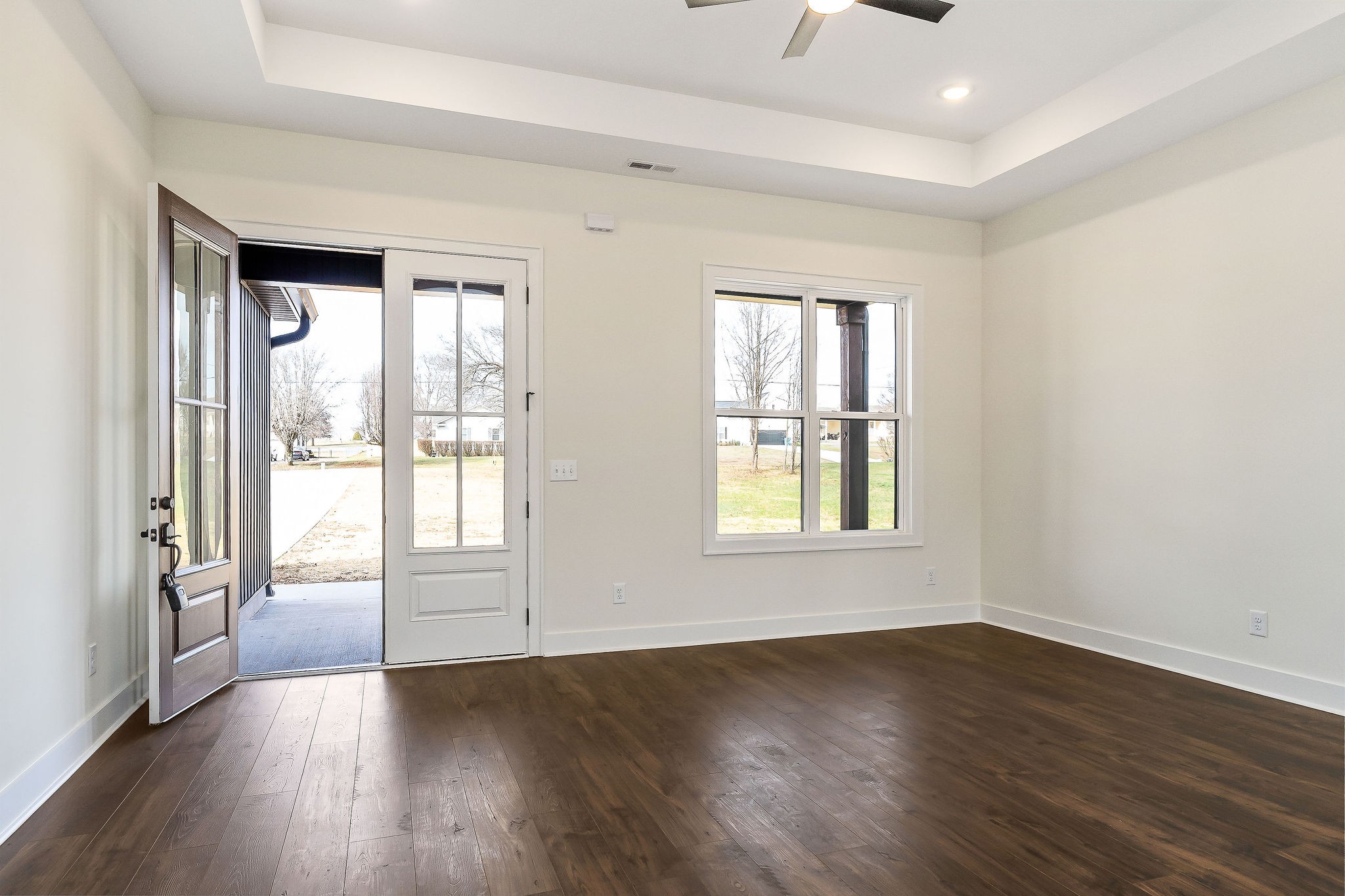 209 Brandon Drive McMinnville, TN 37110 - Photo 7 of 31 an empty room with wooden floor and windows