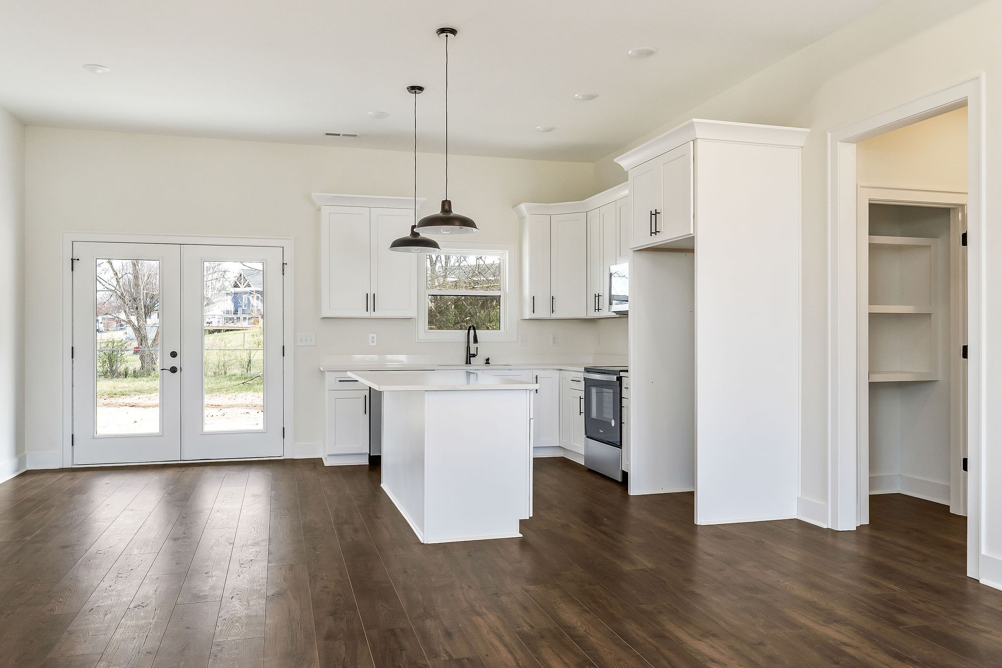209 Brandon Drive McMinnville, TN 37110 - Photo 9 of 31 a kitchen with a refrigerator a sink and white cabinets