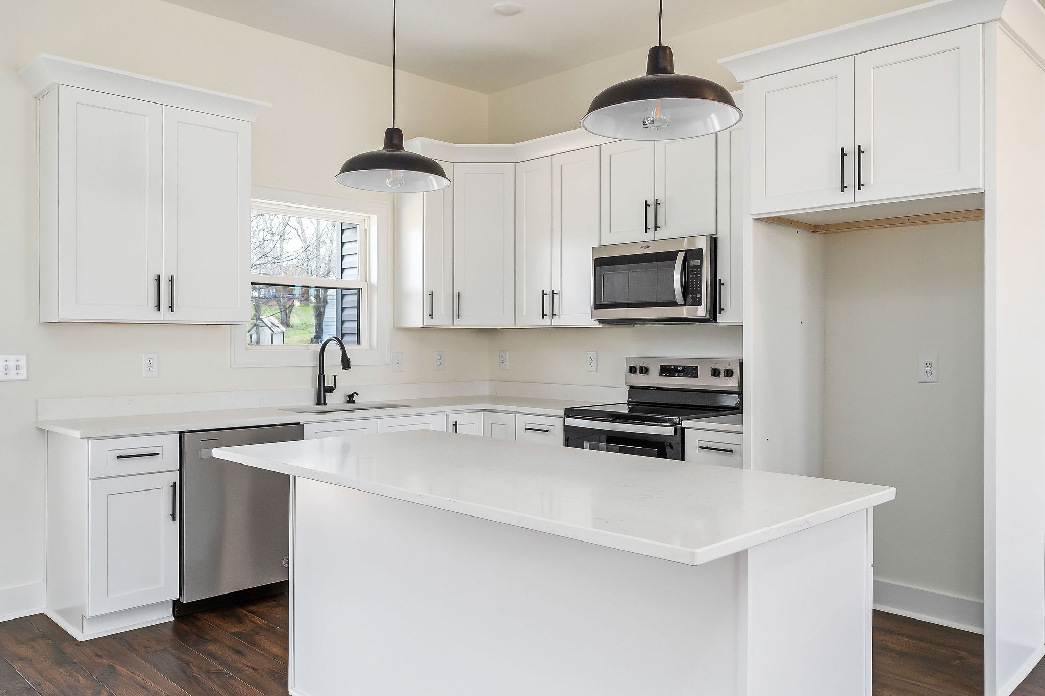 209 Brandon Drive McMinnville, TN 37110 - Photo 10 of 31 a kitchen with stainless steel appliances a stove a microwave and white cabinets