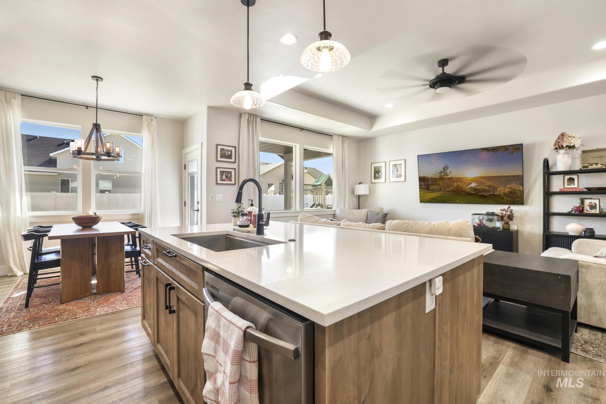 1231 Frank Henry Road Twin Falls, ID 83301 - Photo 48 of 48 Kitchen with open floor plan, wood finish cabinetry, dishwasher, an island with sink, and light wood finished floors