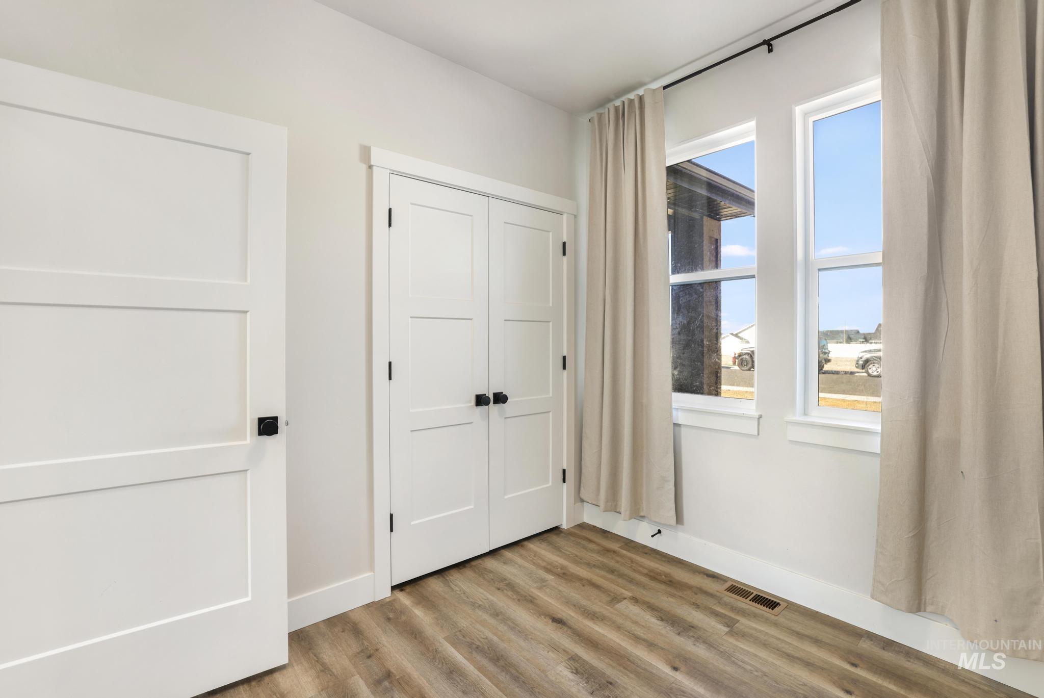 1231 Frank Henry Road Twin Falls, ID 83301 - Photo 15 of 48 Unfurnished bedroom featuring light wood-style floors and a closet