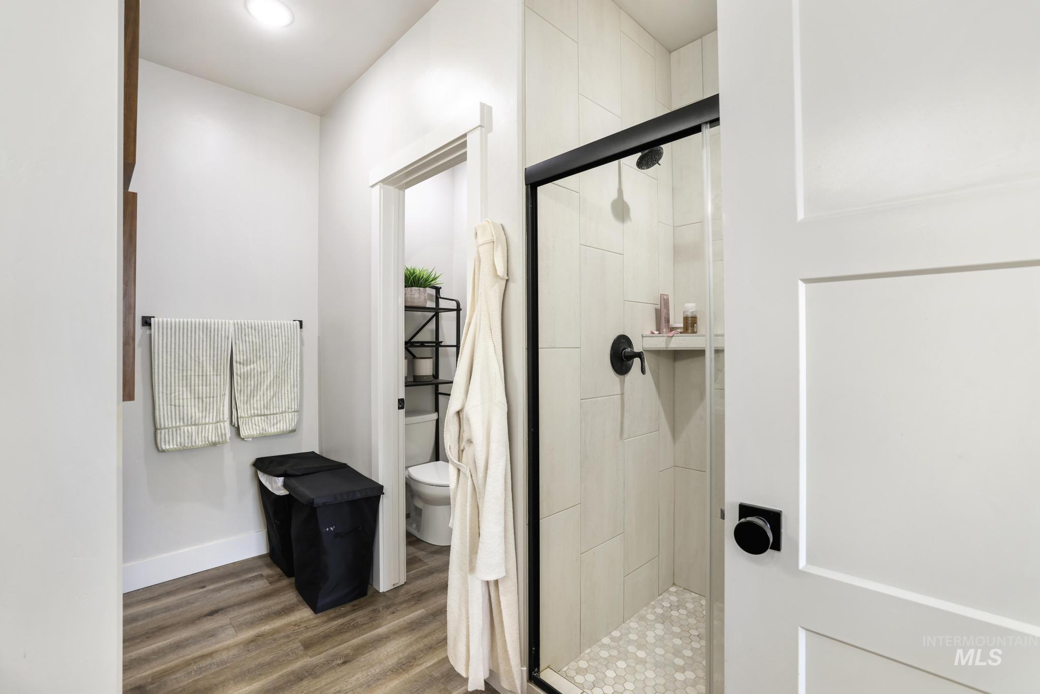 1231 Frank Henry Road Twin Falls, ID 83301 - Photo 20 of 48 Bathroom with a shower stall, dark wood-style floors, and recessed lighting