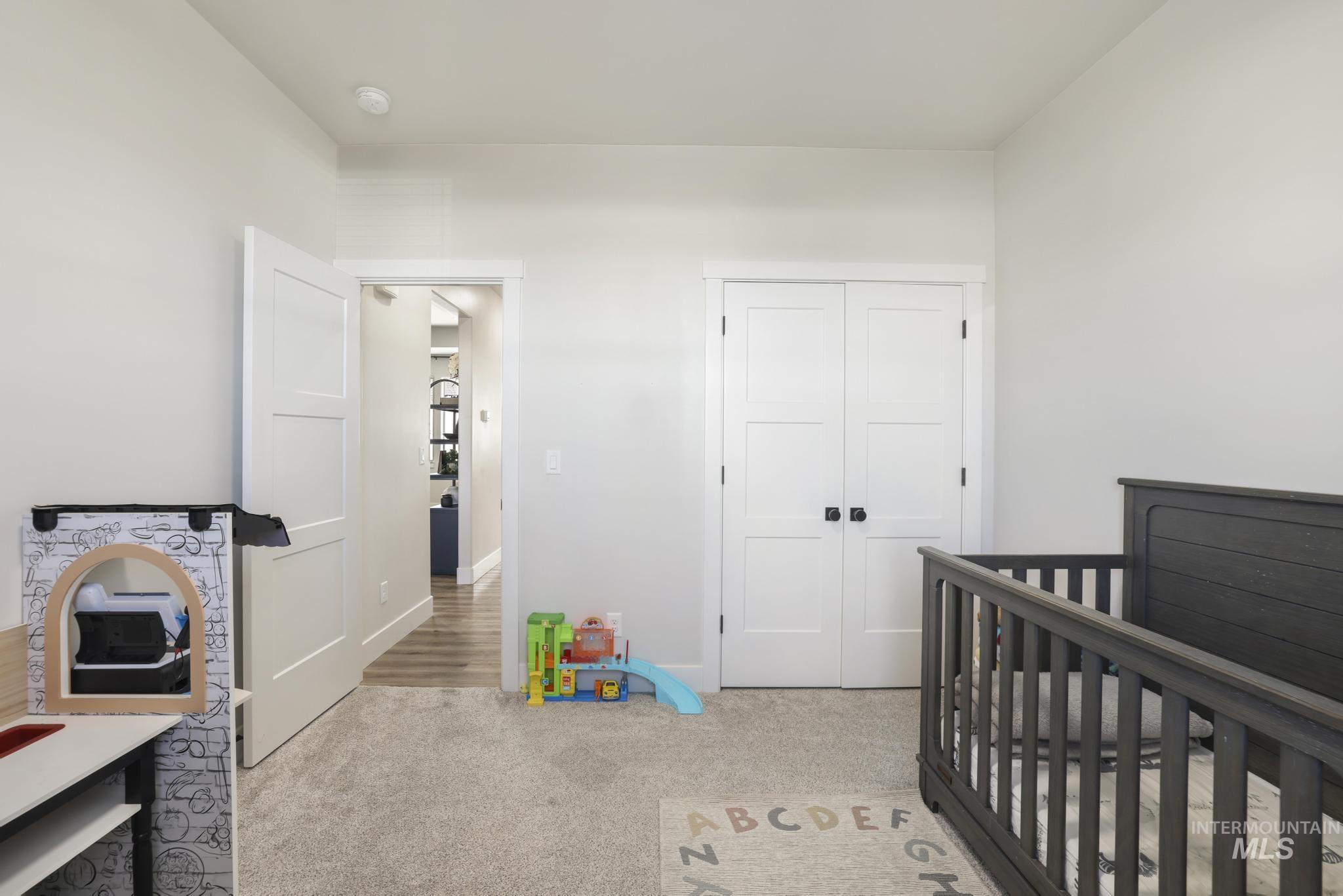1231 Frank Henry Road Twin Falls, ID 83301 - Photo 23 of 48 Bedroom featuring a crib, light colored carpet, and a closet