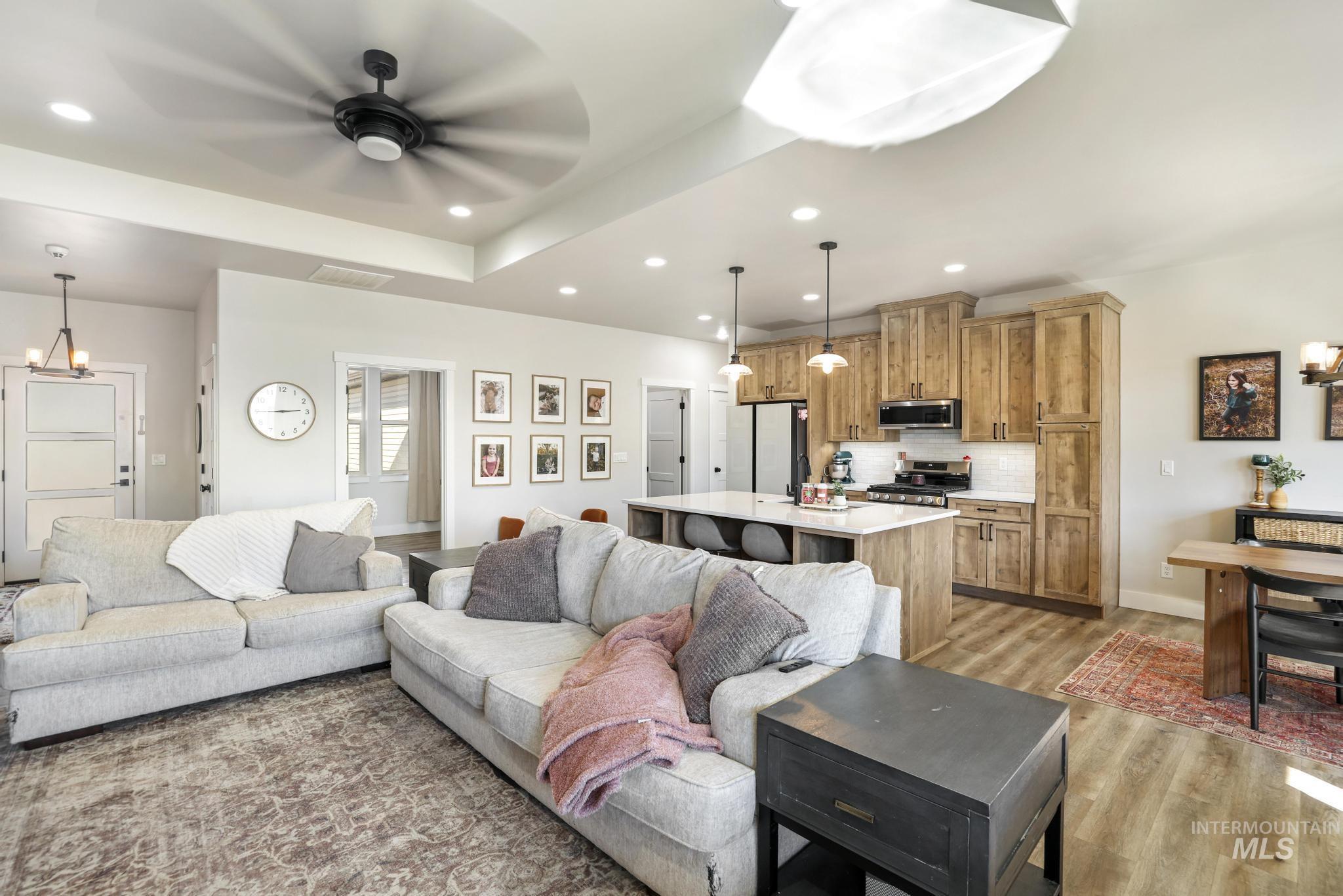 1231 Frank Henry Road Twin Falls, ID 83301 - Photo 6 of 48 Living area featuring hanging lights, a ceiling fan, and light wood-style flooring