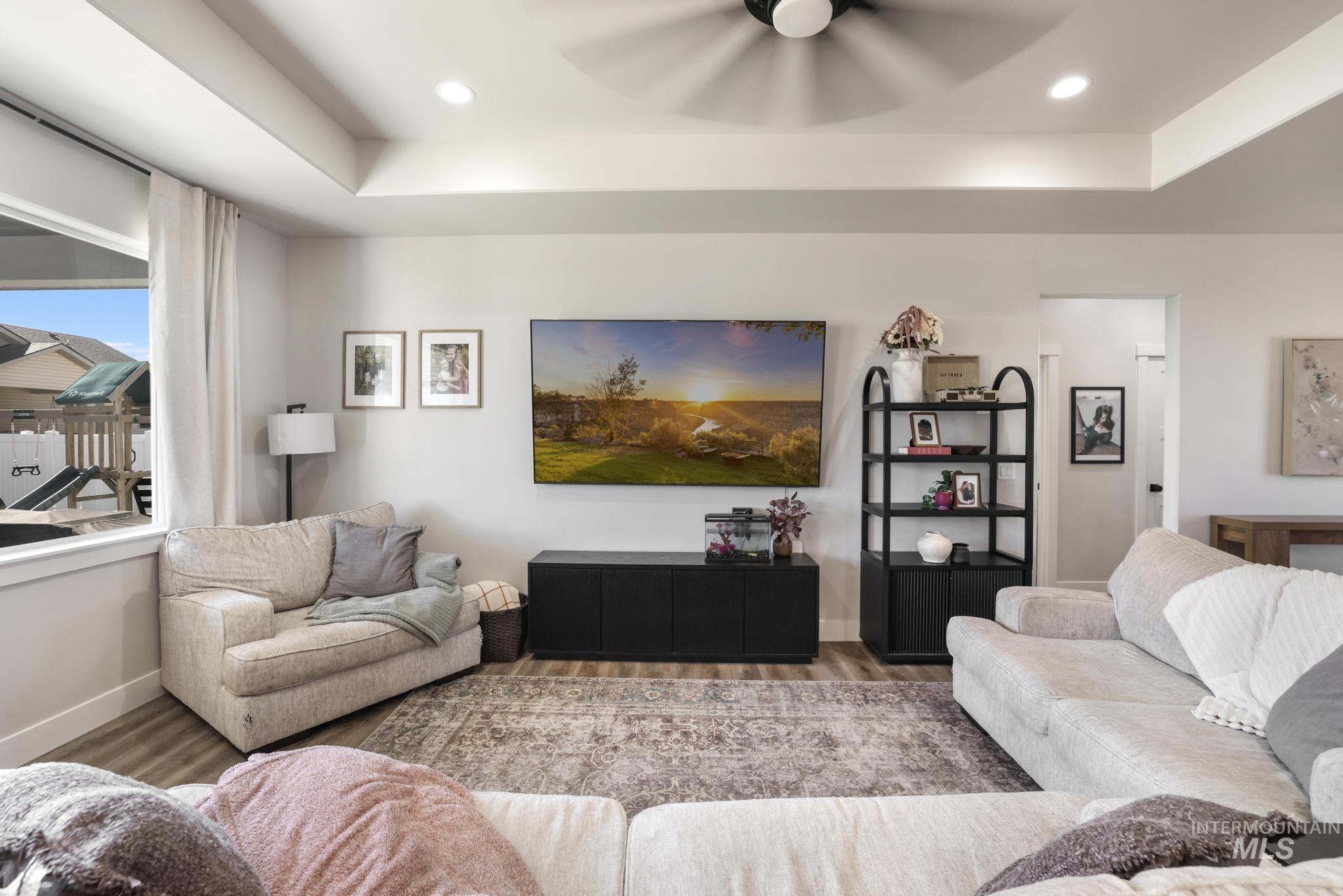 1231 Frank Henry Road Twin Falls, ID 83301 - Photo 7 of 48 Living area with ceiling fan, wood finished floors, recessed lighting, and a raised ceiling