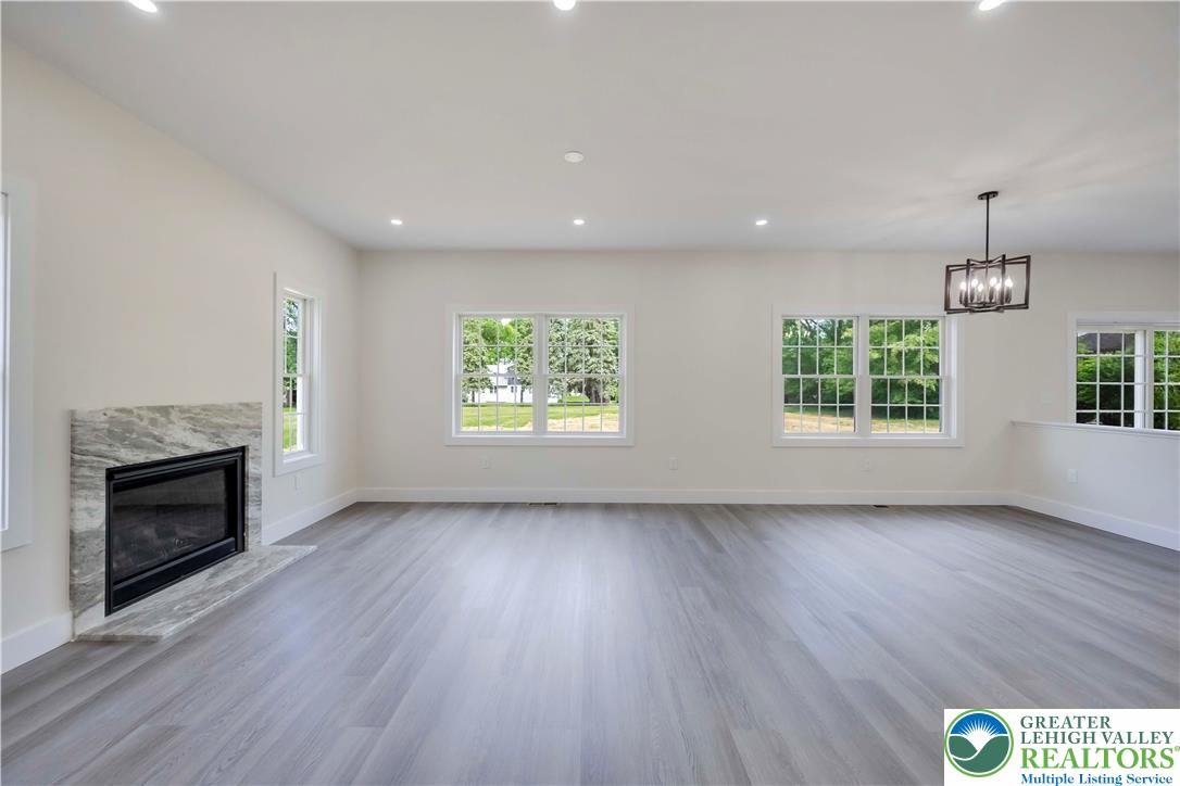 2840 Jacksonville Road Bethlehem, PA 18017 - Photo 12 of 29 an empty room with wooden floor fireplace and windows