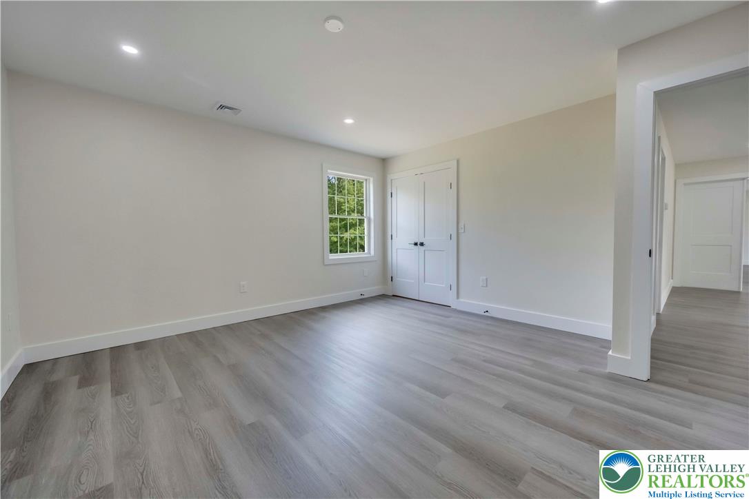 2840 Jacksonville Road Bethlehem, PA 18017 - Photo 25 of 29 an empty room with wooden floor and windows