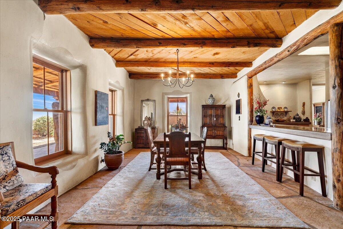 18300 Peacemaker Drive Dewey, AZ 86327 - Photo 30 of 47 a dining room with wooden floor a chandelier a wooden table and chairs