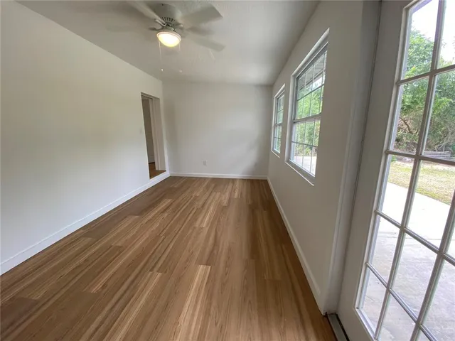 wooden floor in an empty room with a window