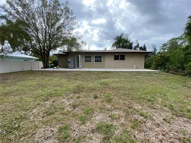 a front view of house with yard and trees