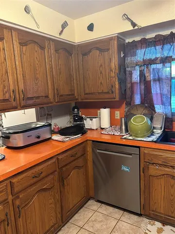 a kitchen with stainless steel appliances granite countertop a sink and cabinets